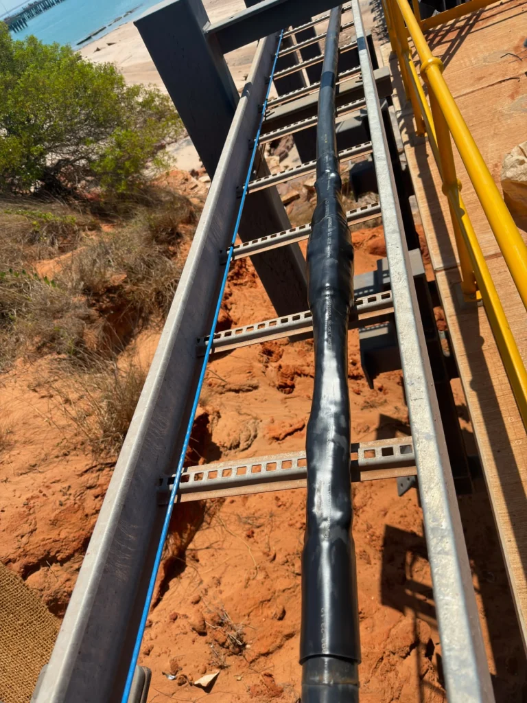 Heat-shrink high-voltage cable joint on a cable ladder