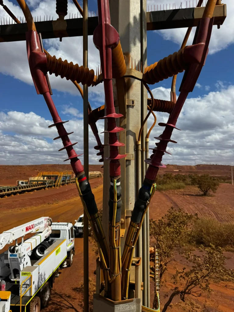 High-voltage cable terminations on a pole at a mine site